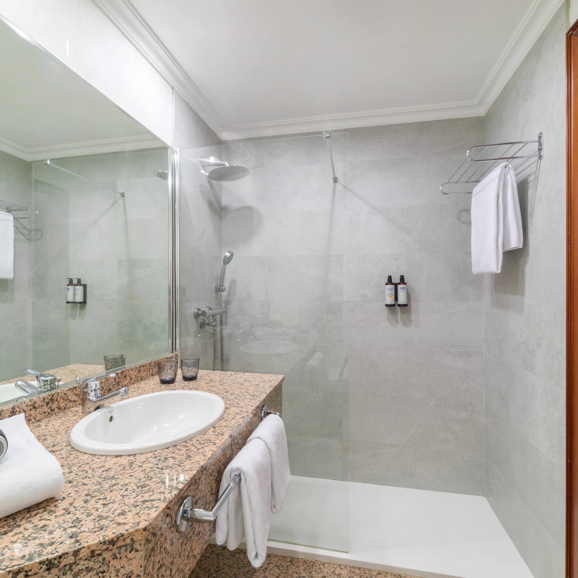 a bathroom with a shower and sink