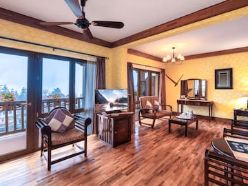 a room with a wood floor and a ceiling fan