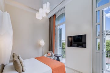 a bedroom with a bed and a television