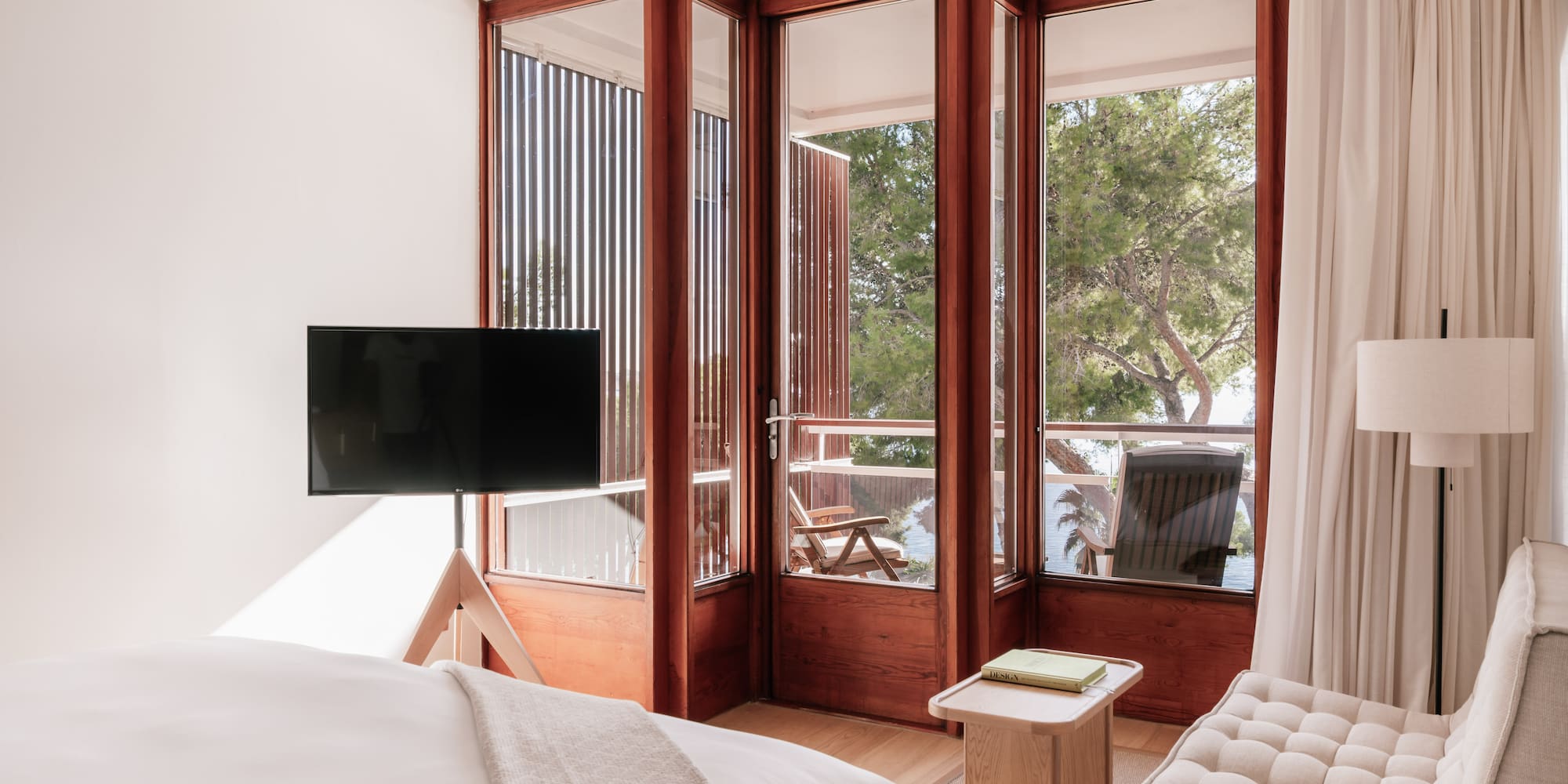 a bedroom with a television and a window