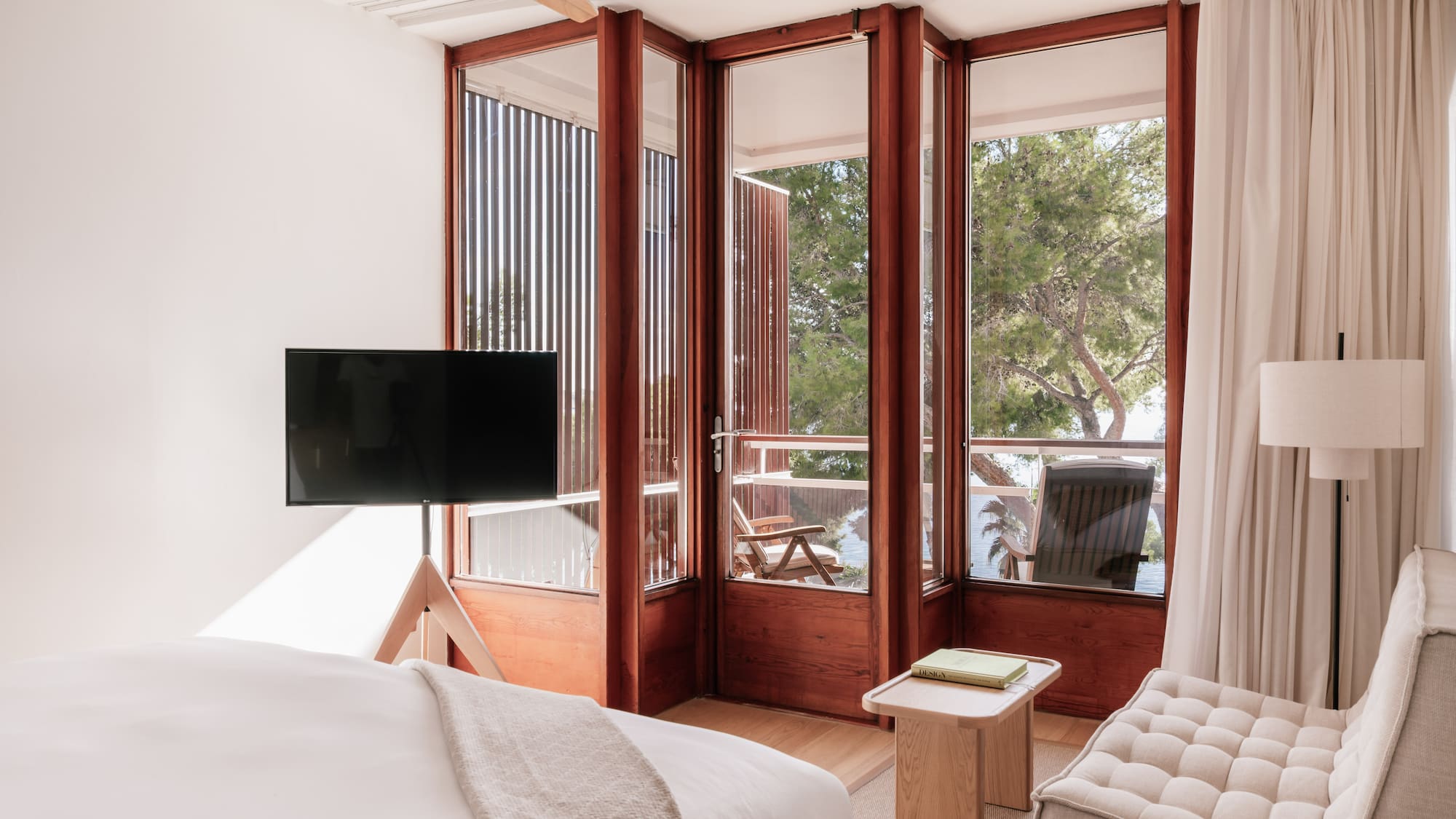 a bedroom with a television and a window