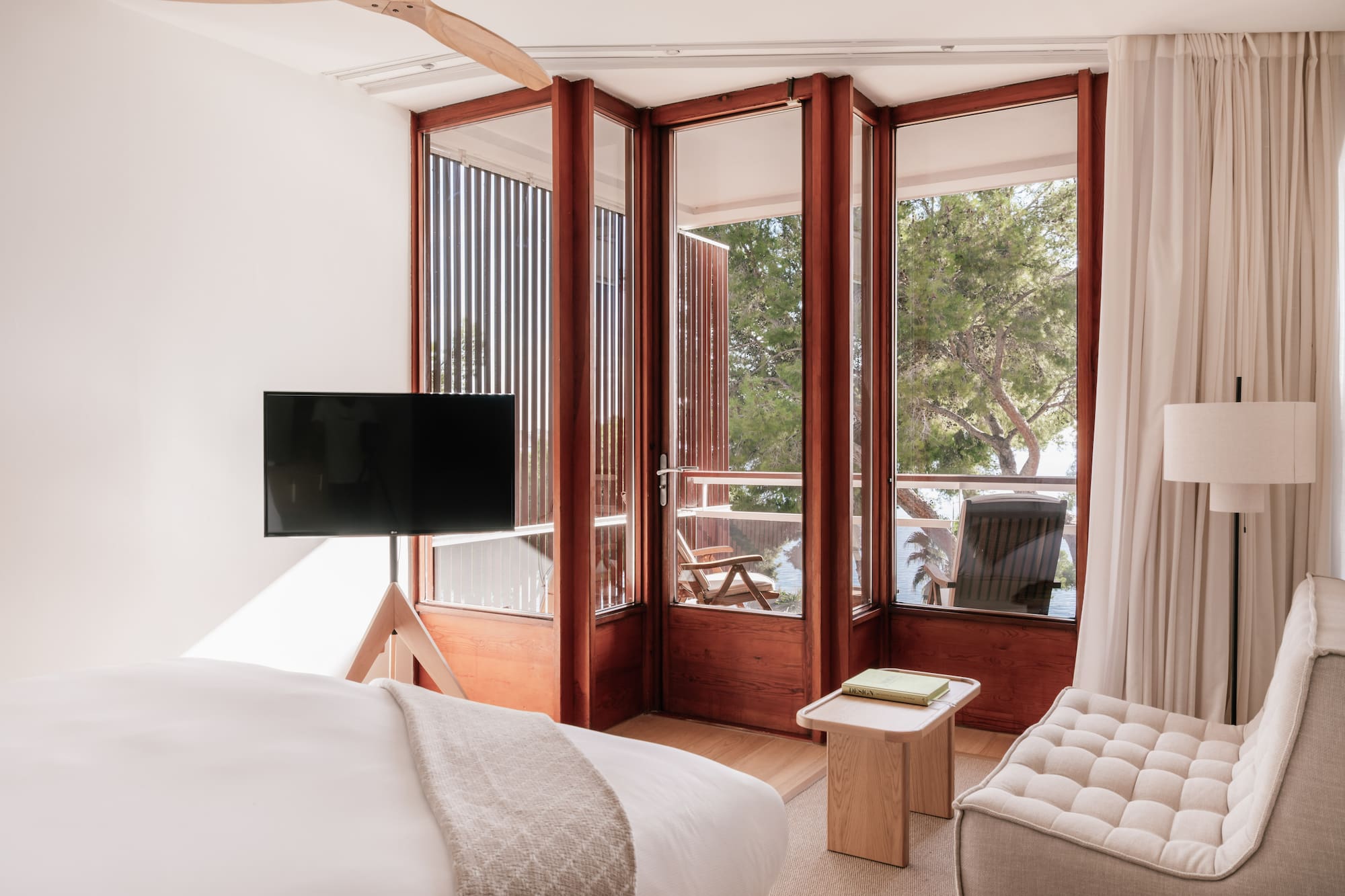 a bedroom with a television and a window