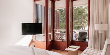 a bedroom with a television and a window