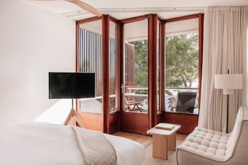 a bedroom with a television and a window