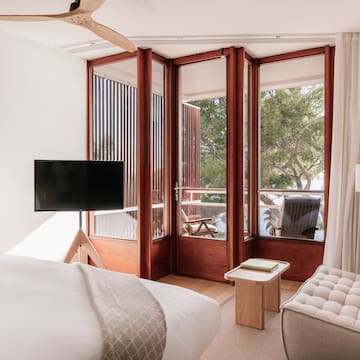 a bedroom with a television and a window