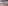 Modern empty conference room with rows of tables, chairs, and bottled water.