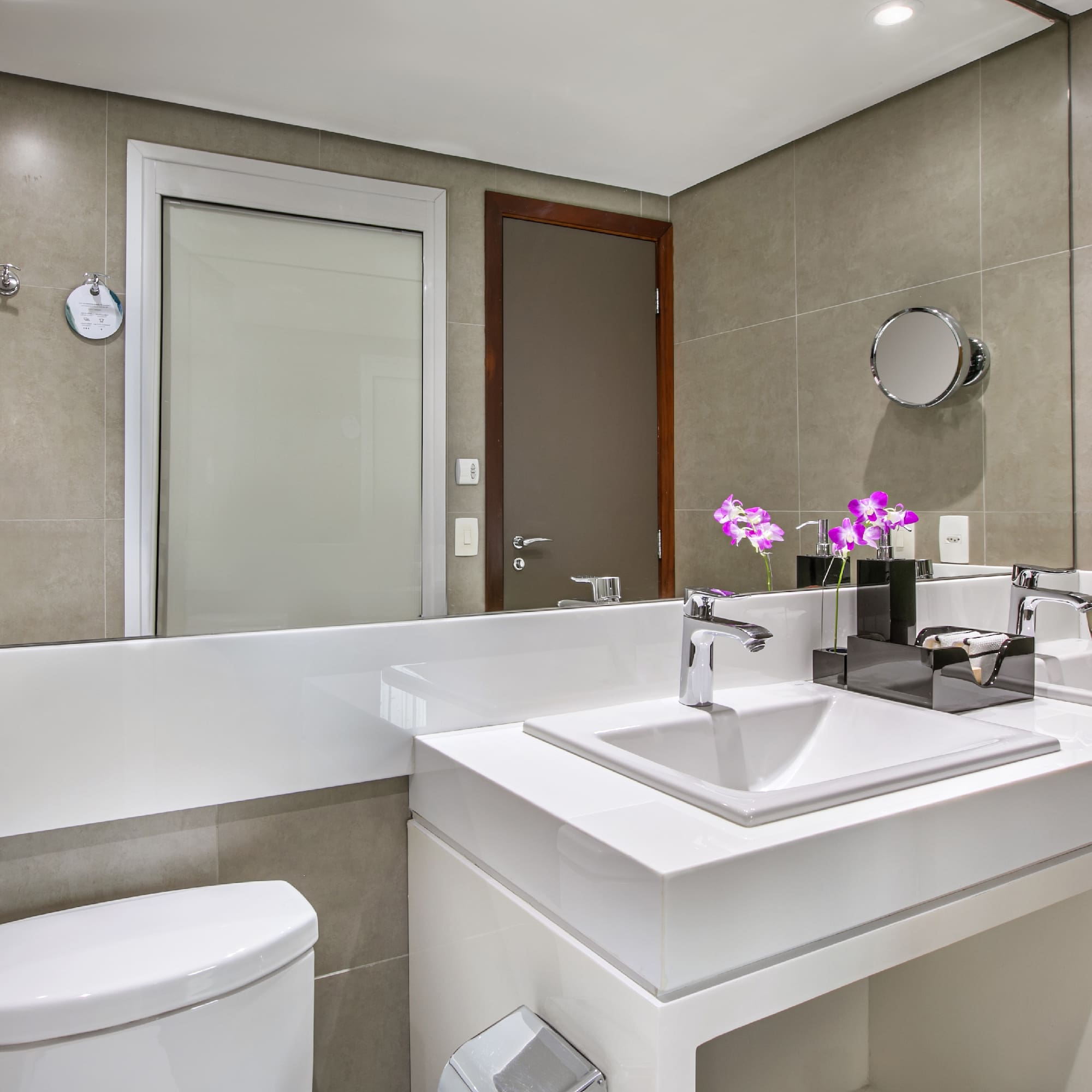 a bathroom with a sink toilet and mirror
