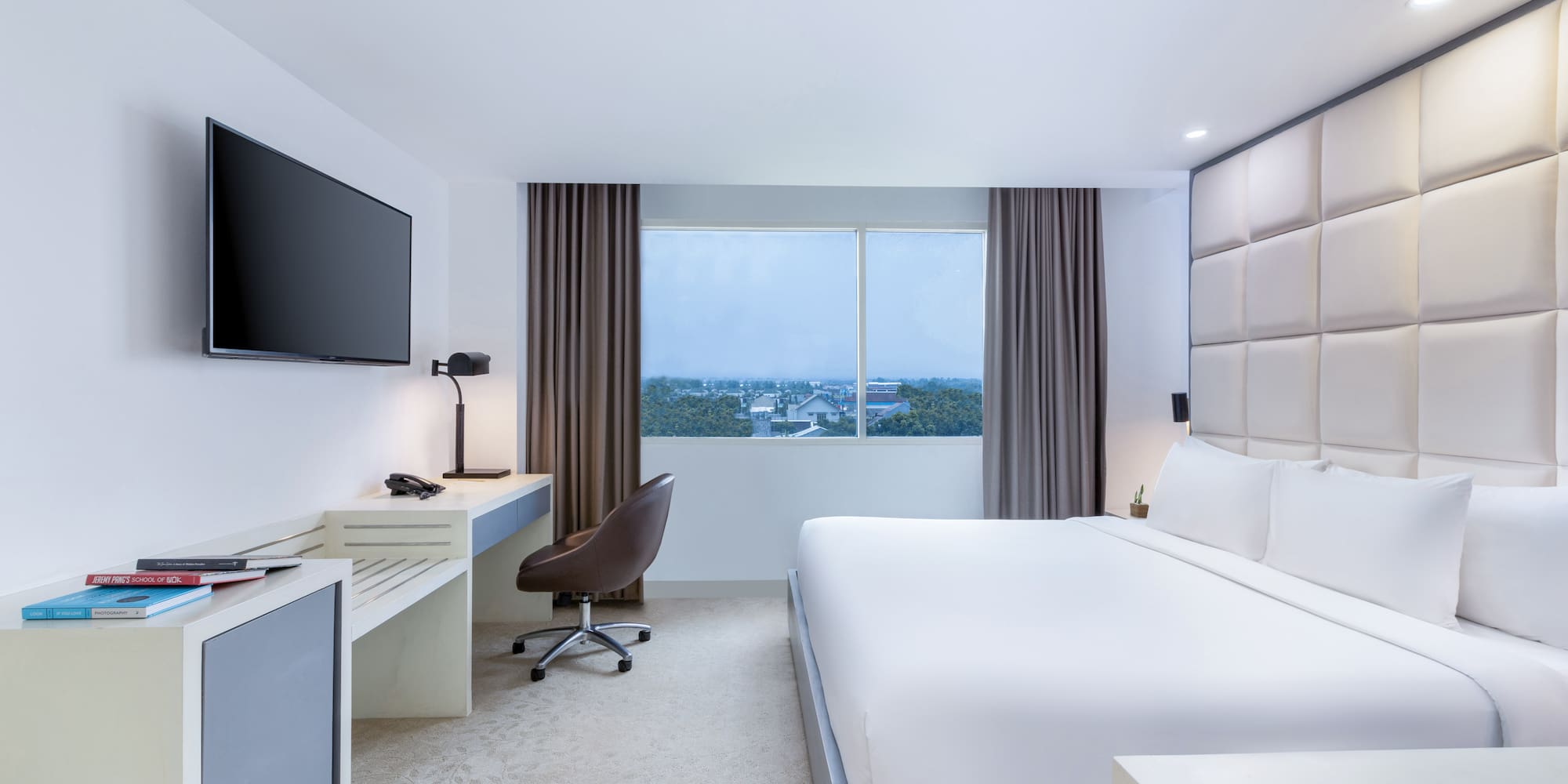 a room with a bed and a television