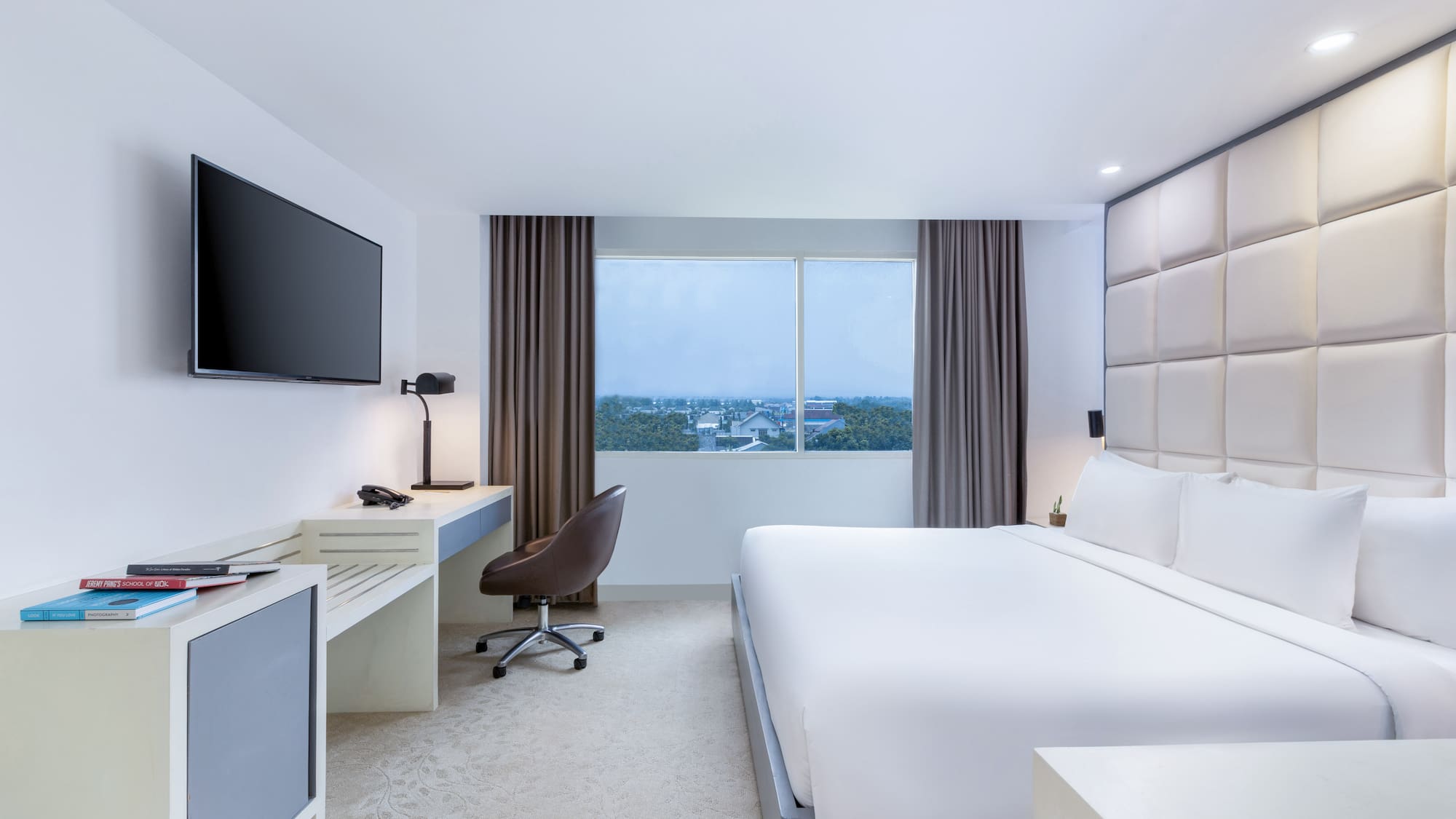 a room with a bed and a television