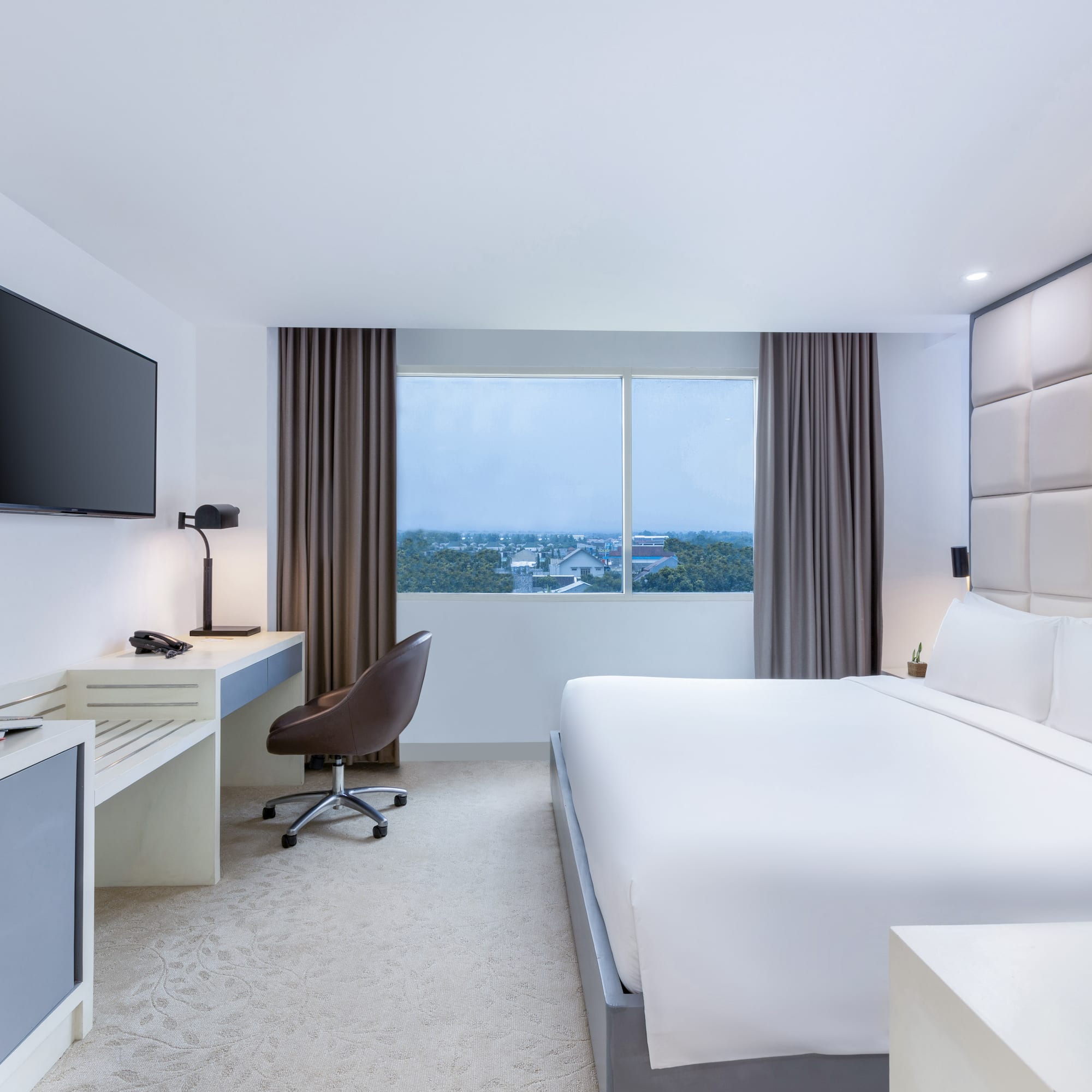 a room with a bed and a television