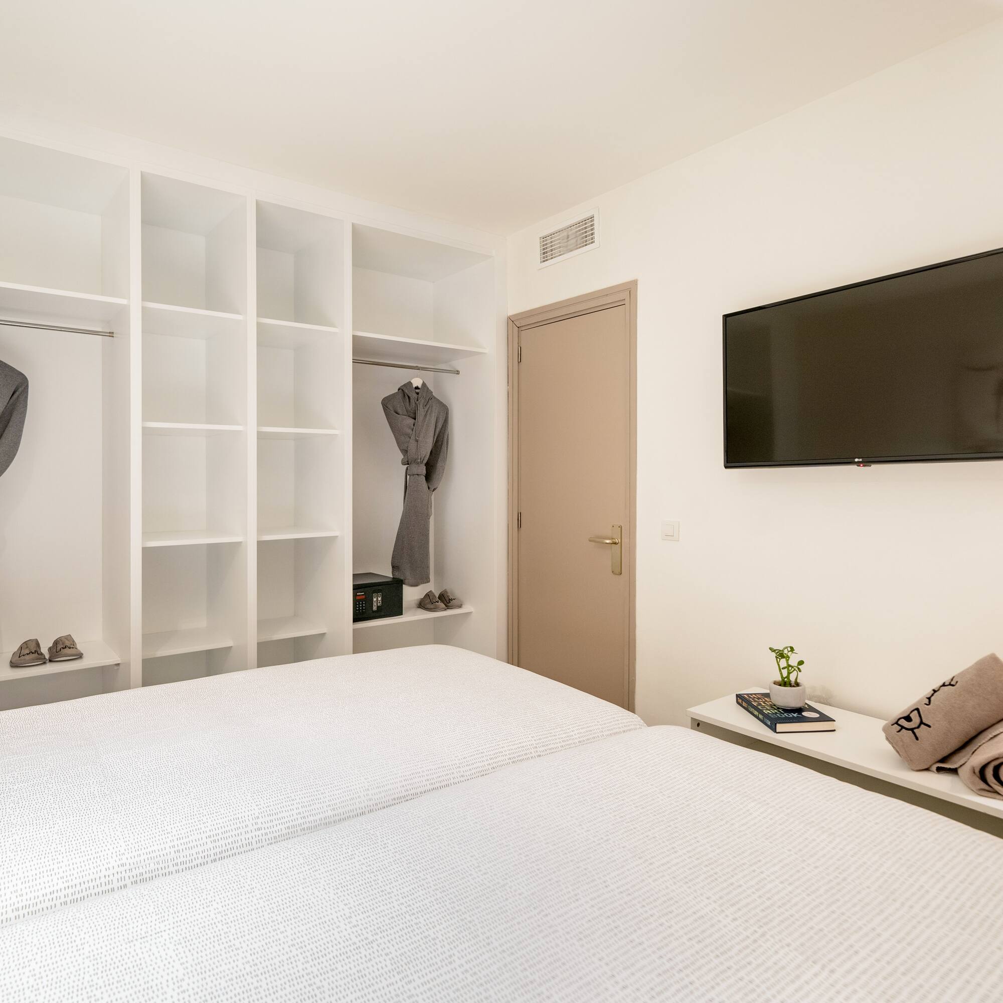 a room with a tv and a bed