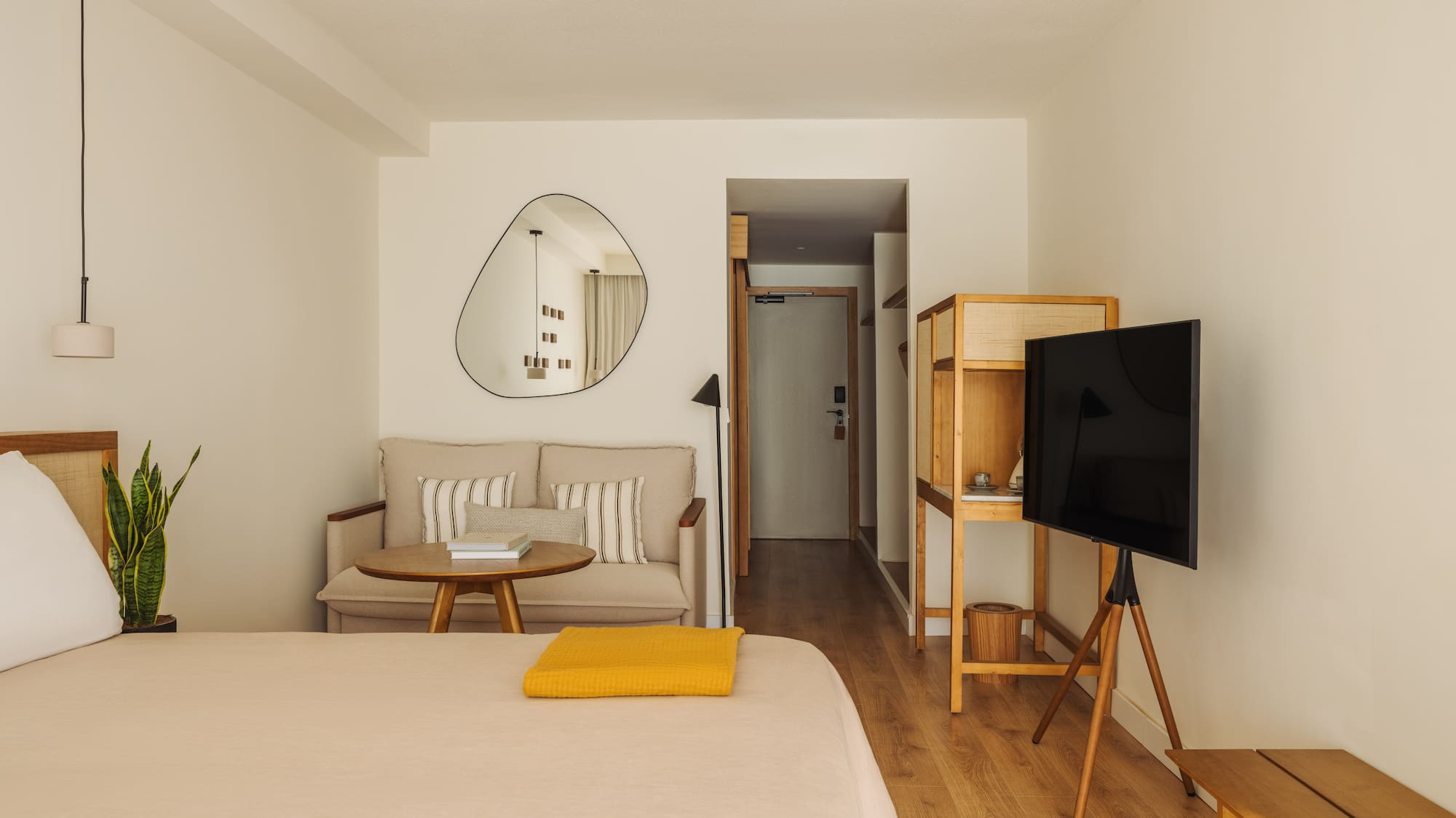 a room with a bed and a television