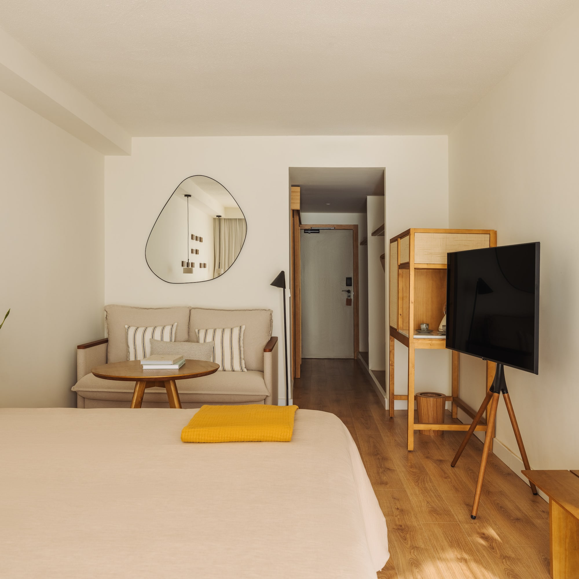 a room with a bed and a television