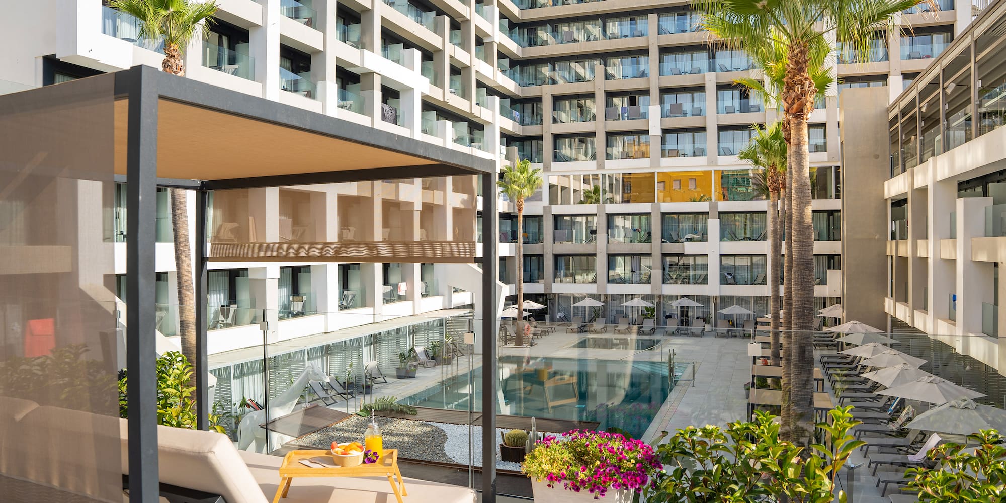 a pool in front of a hotel