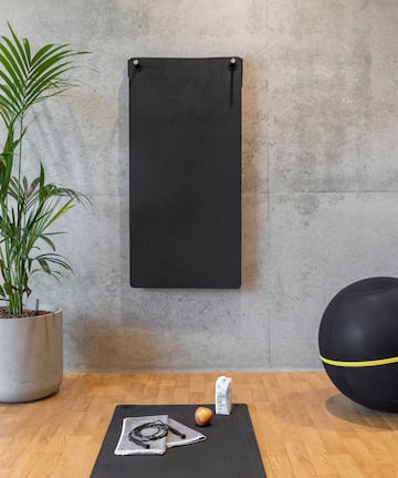 a yoga mat and exercise balls on a wooden floor