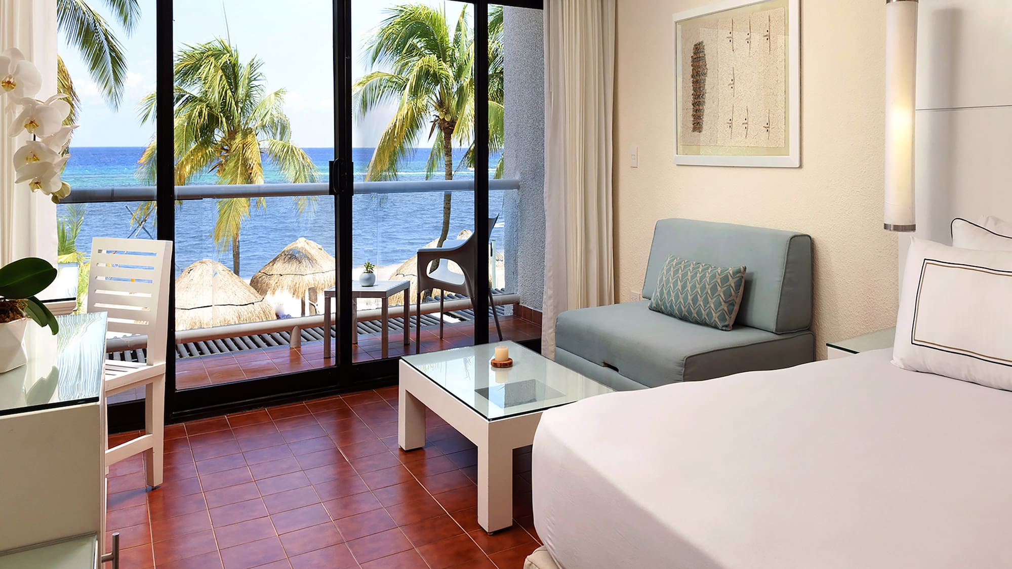 a room with a bed and a table and chairs