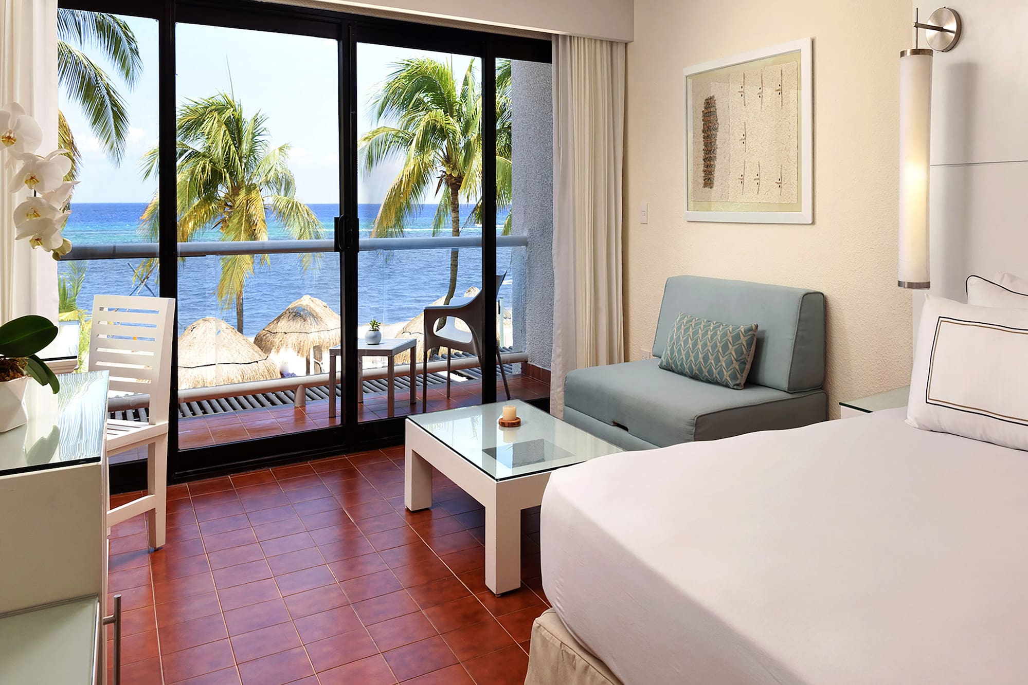 a room with a bed and a table and chairs