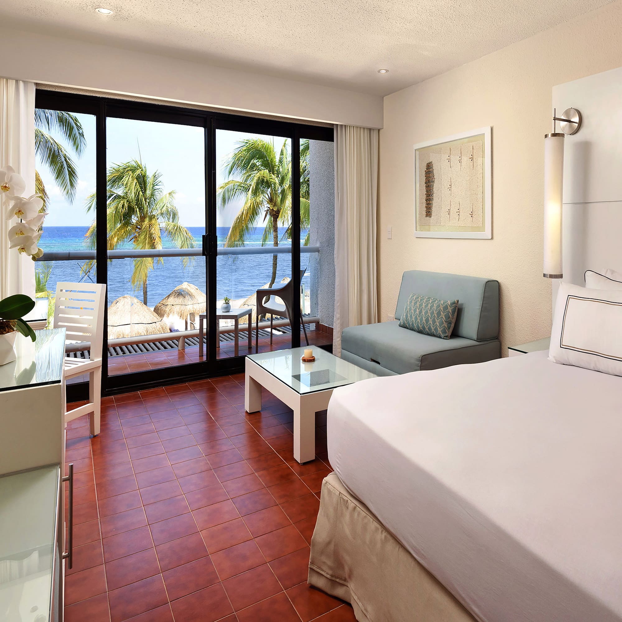 a room with a bed and a table and chairs