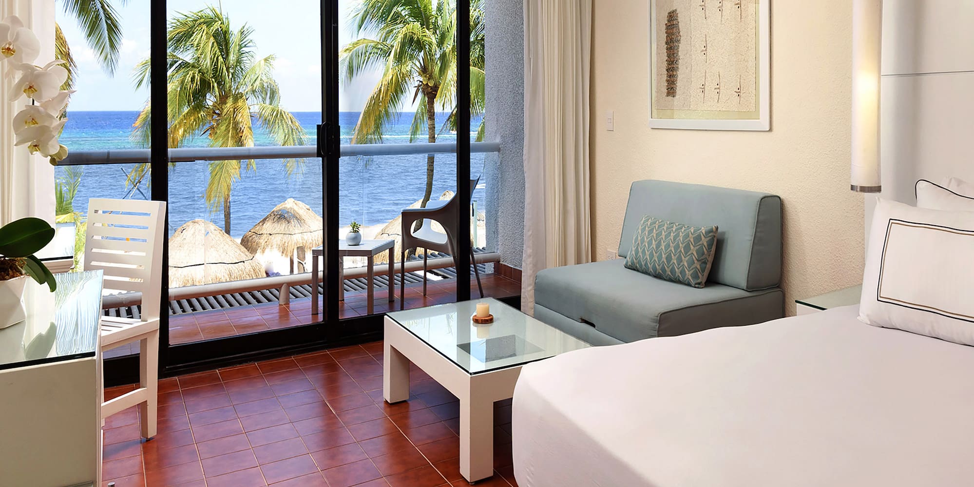 a room with a bed and a table and chairs