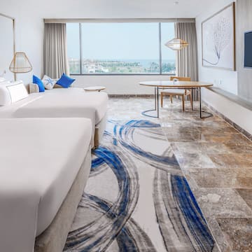a room with two beds and a table