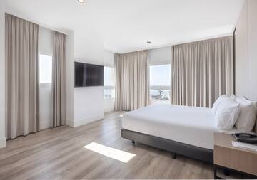 a bedroom with a bed and a television