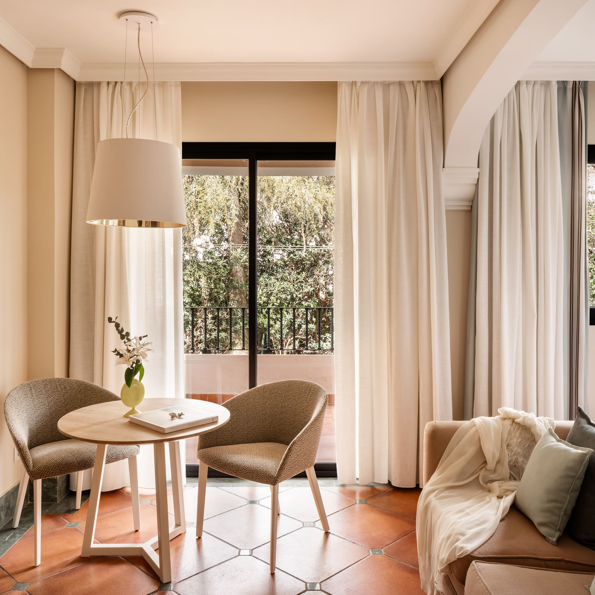 a living room with a table and chairs