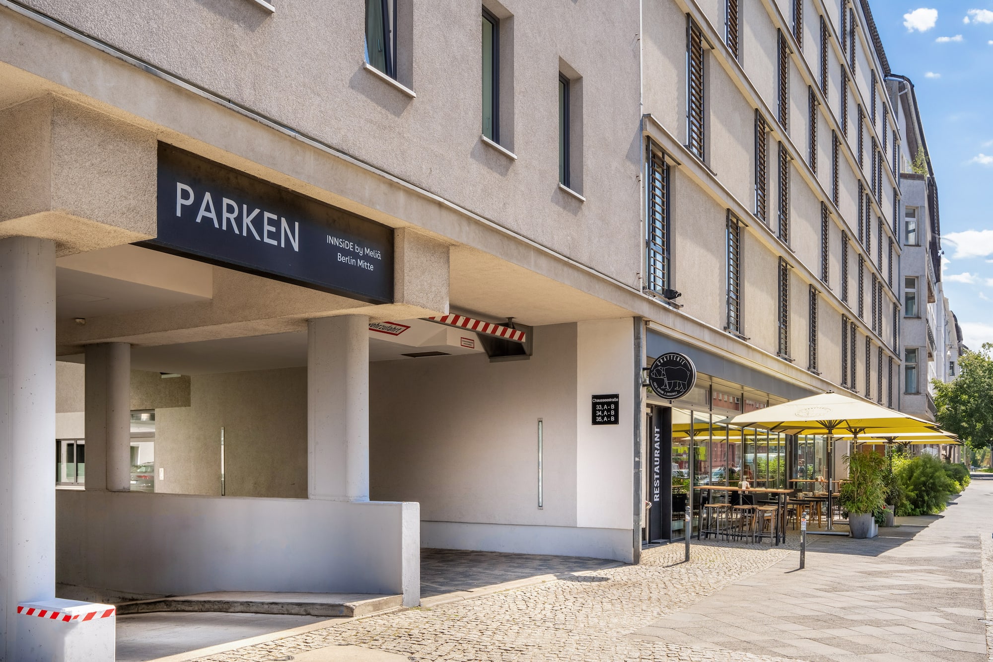 INNSIDE by Melia Berlin Mitte parking, adjacent restaurant with outdoor seating.