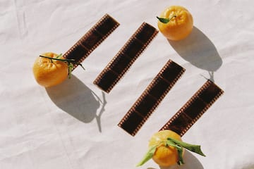 oranges and film strips on a white surface