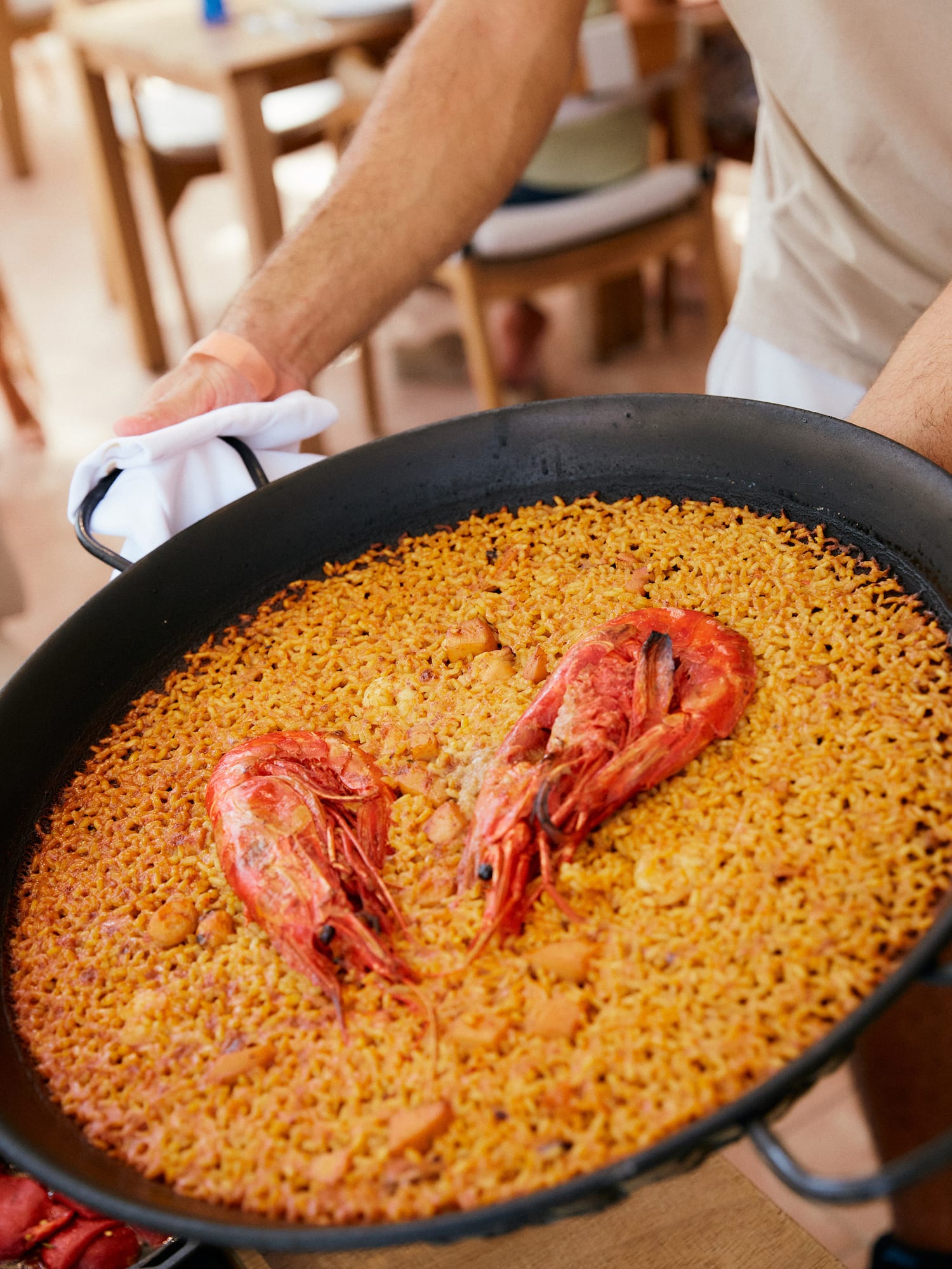 a person holding a pan of food