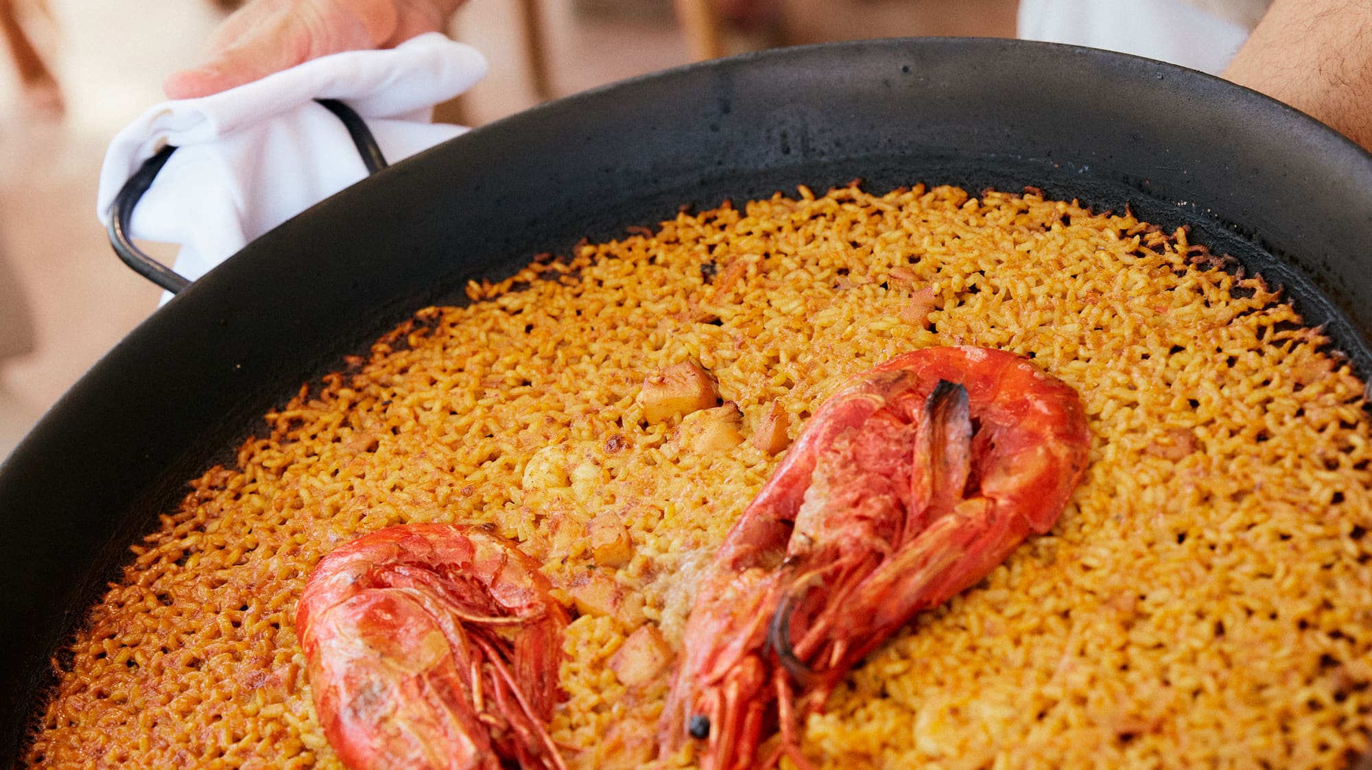 a person holding a pan of food