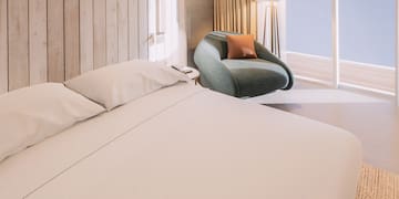 a bed and chair in a room