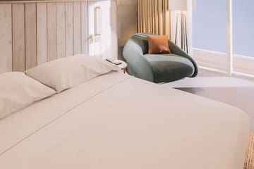 a bed and chair in a room