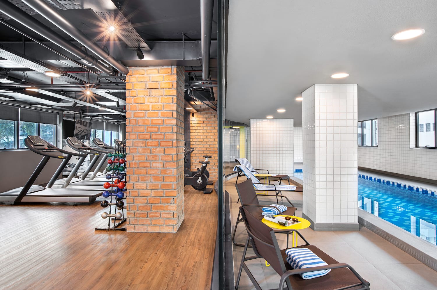 a gym with exercise equipment and a pool