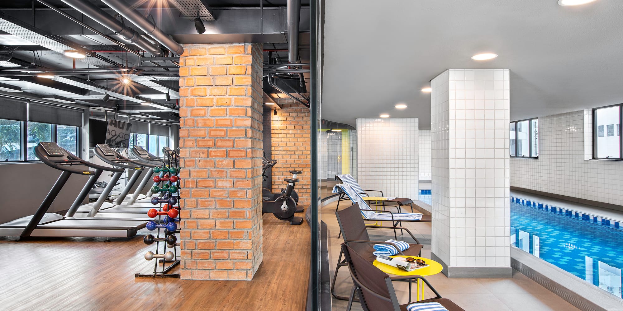 a gym with exercise equipment and a pool