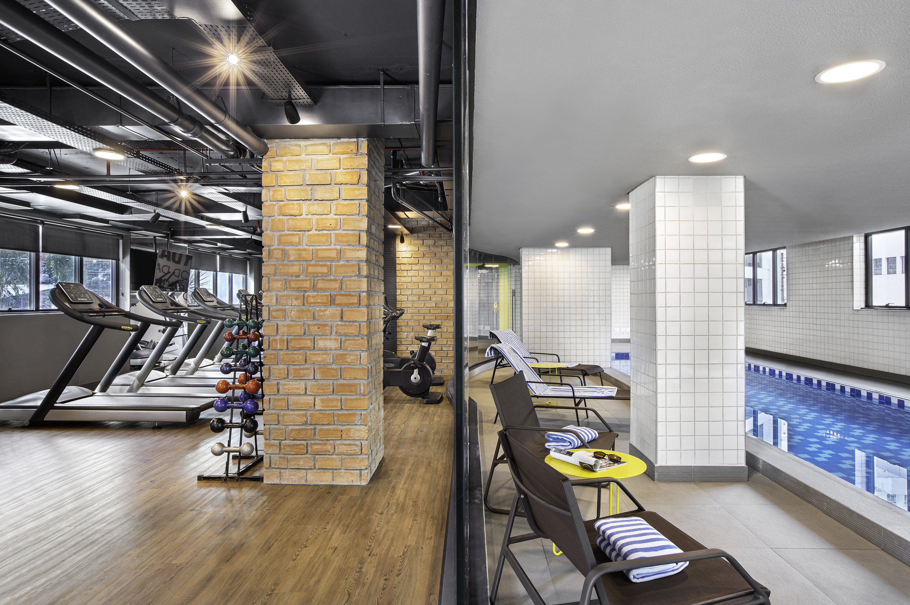 a gym with exercise equipment and a pool