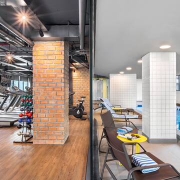 a gym with exercise equipment and a pool
