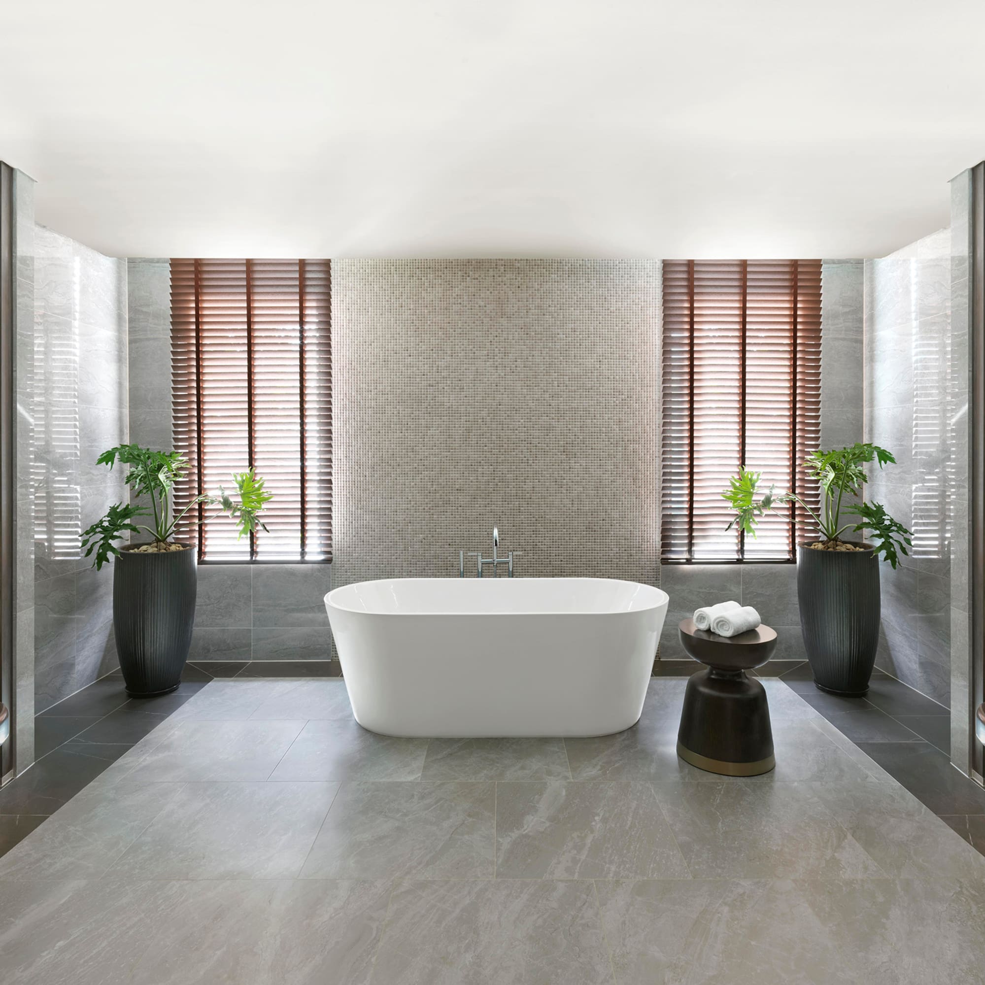 a bathroom with a tub and plants
