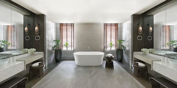 a bathroom with a tub and plants