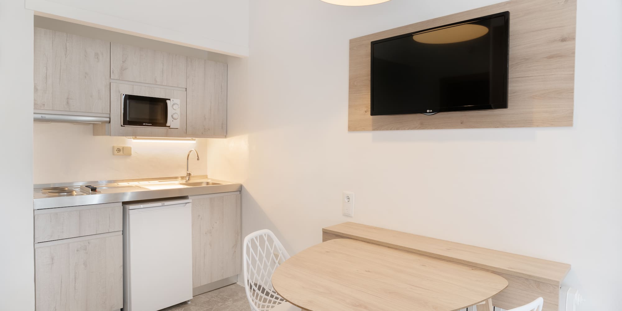 a kitchen with a table and chairs