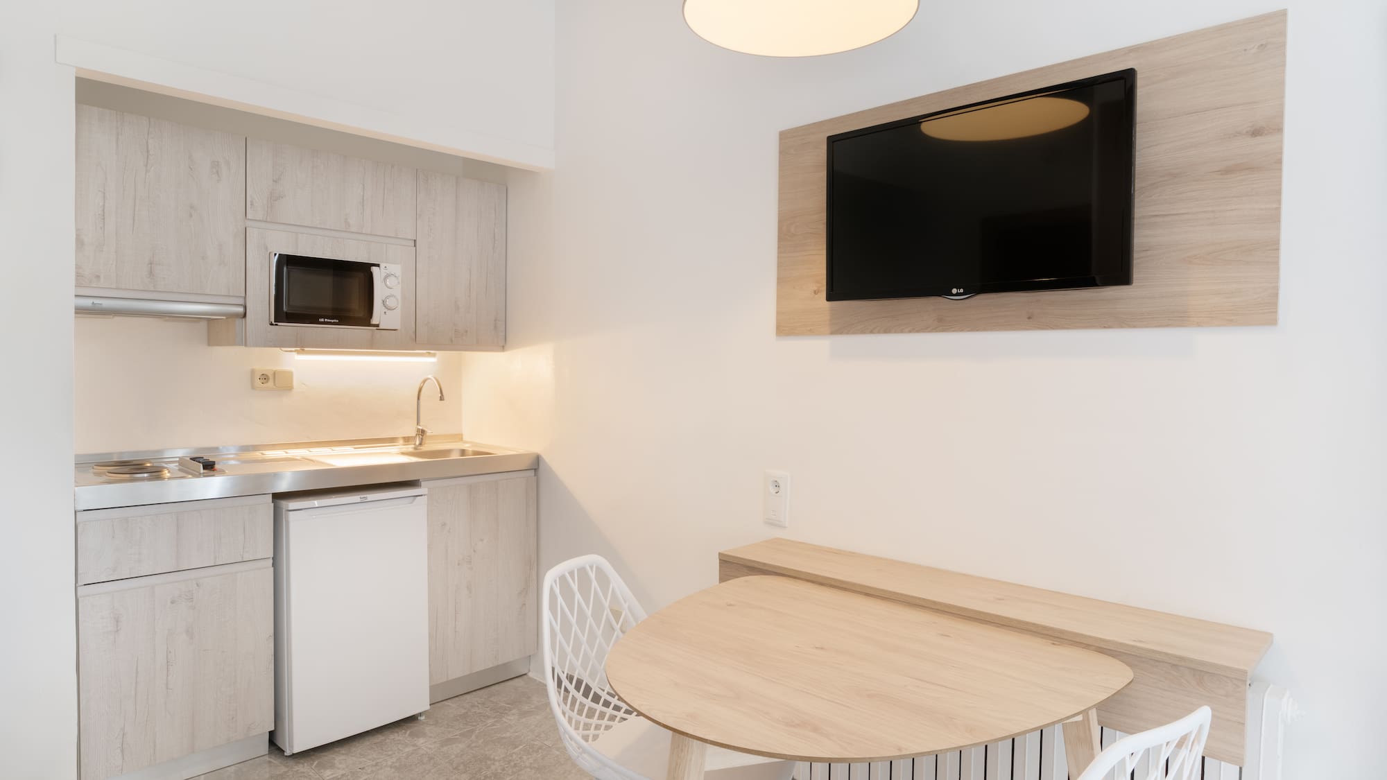 a kitchen with a table and chairs