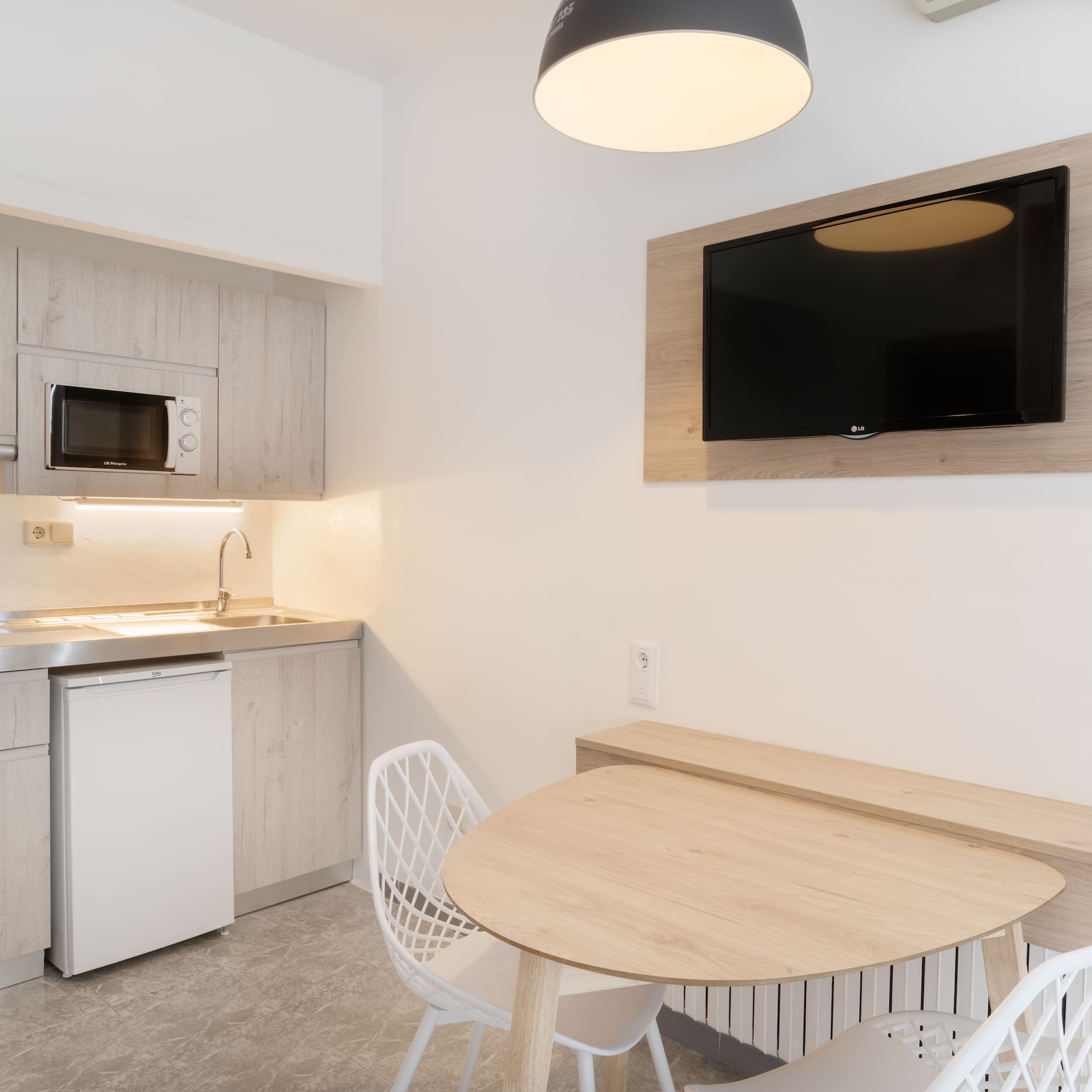 a kitchen with a table and chairs