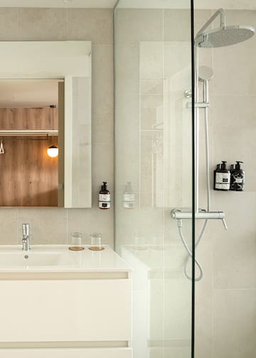 a bathroom with a glass shower door