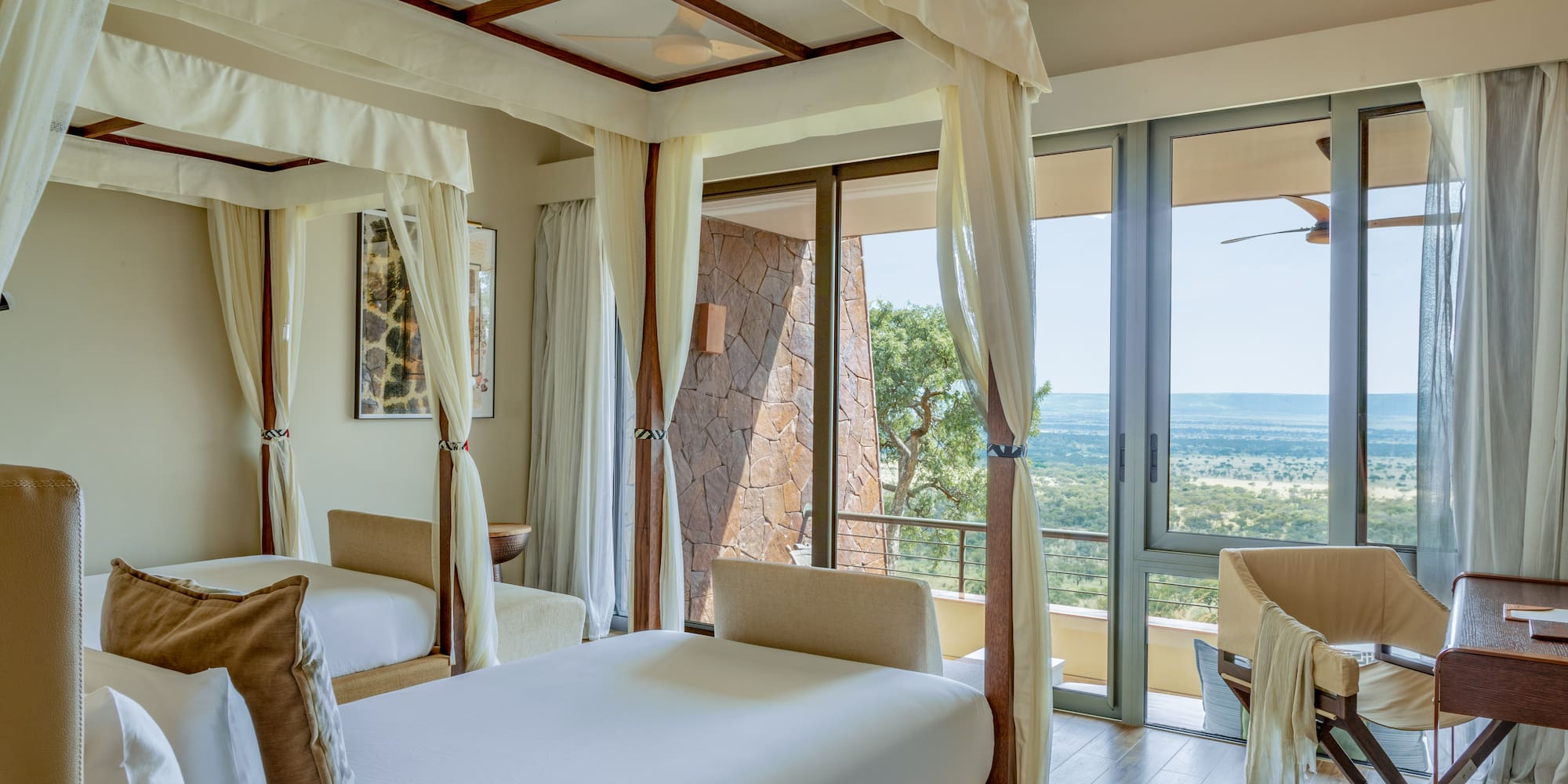 a room with two beds and a view of the valley