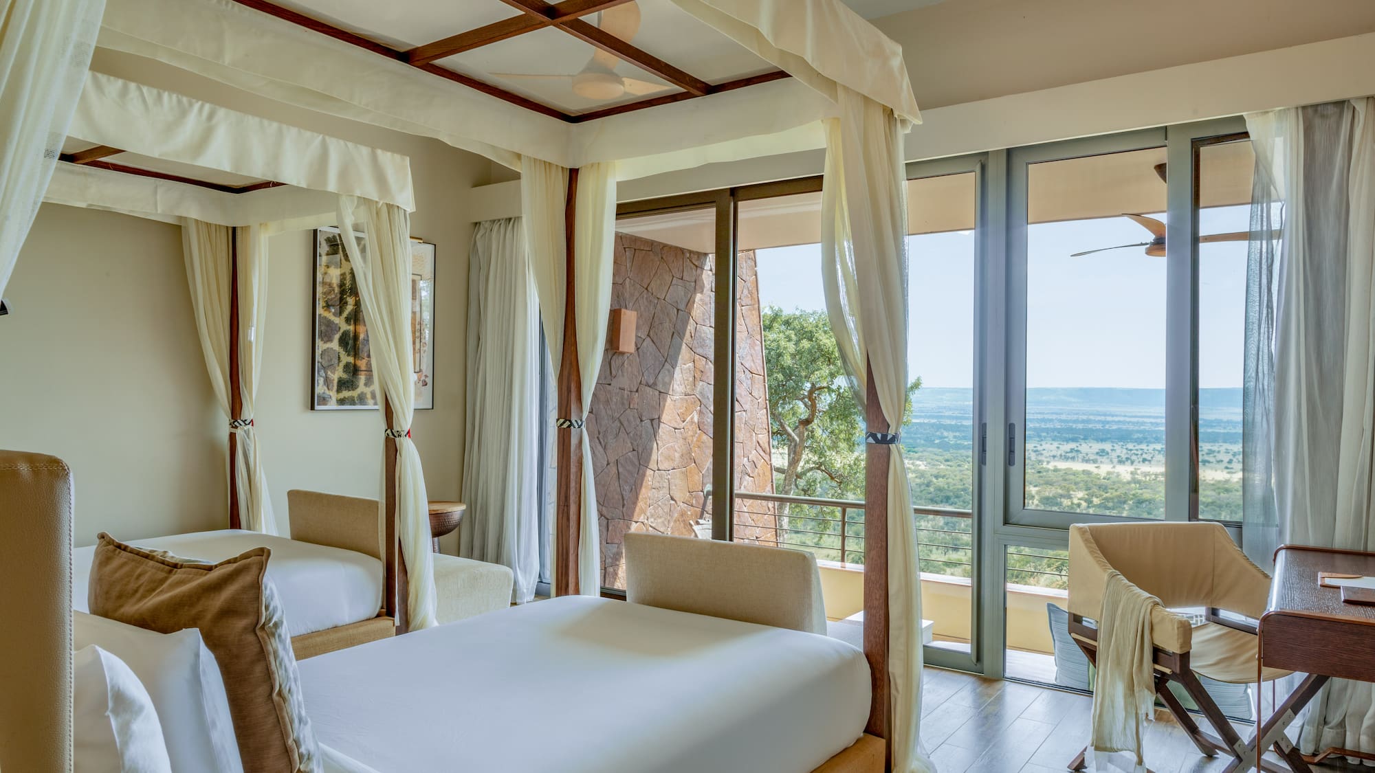 a room with two beds and a view of the valley