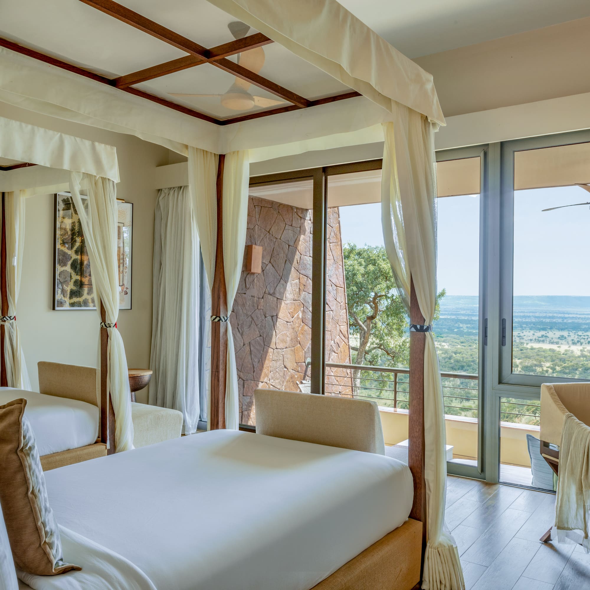 a room with two beds and a view of the valley