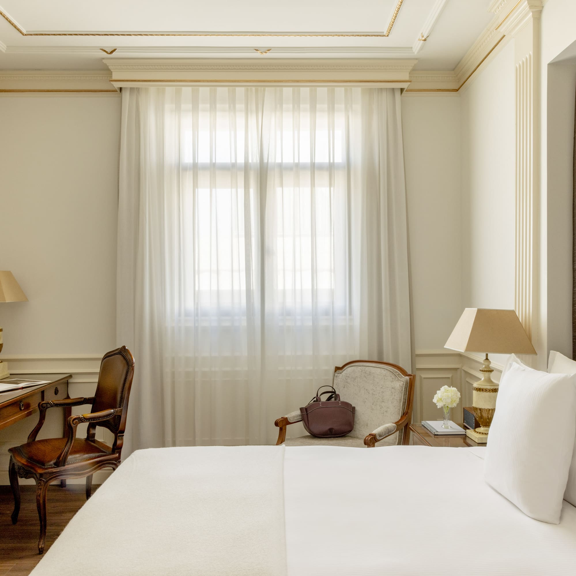 a room with a bed and a desk and chair