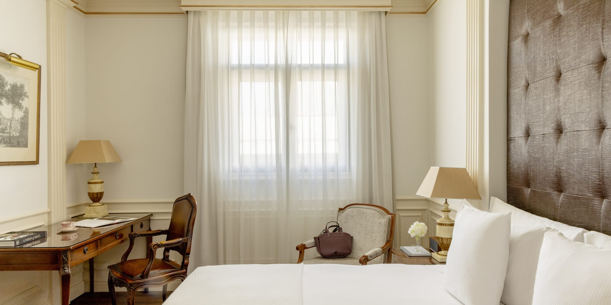 a room with a bed and a desk and chair