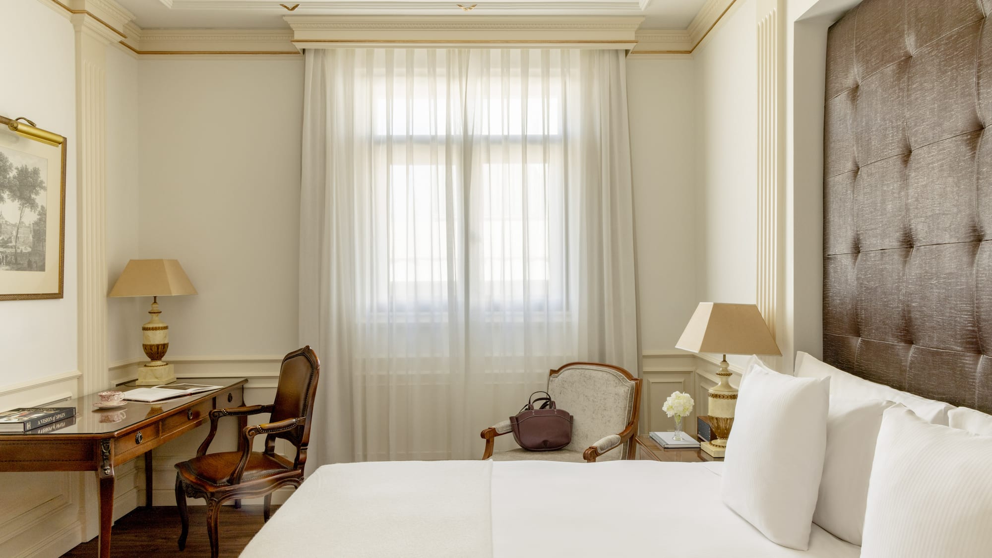 a room with a bed and a desk and chair