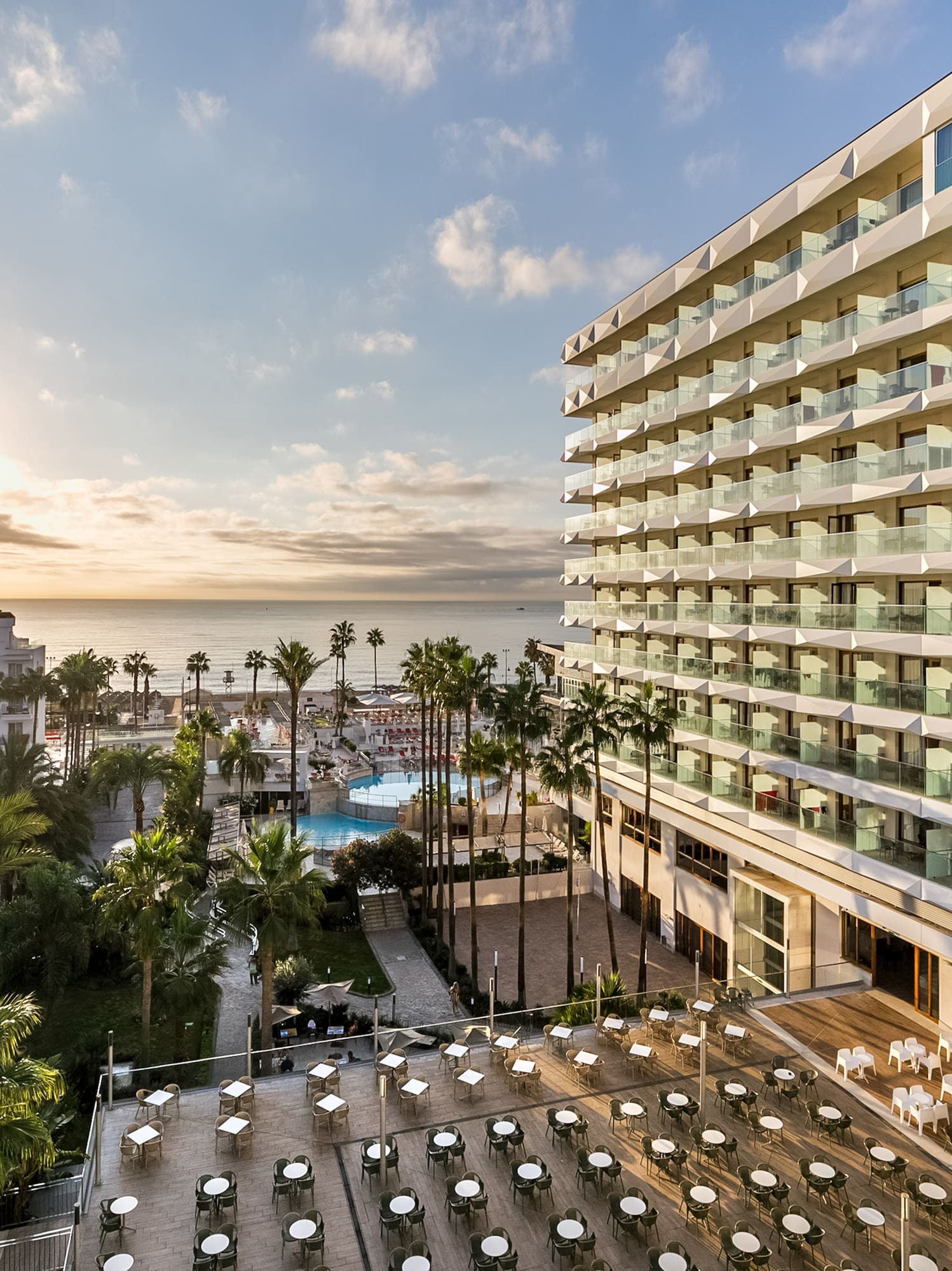 a hotel with a pool and palm trees