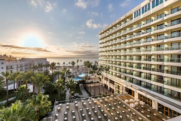 a hotel with a pool and palm trees